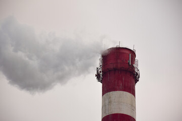 Smoking chimney of a factory or factory on the background of the sky