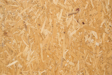 Wooden background, fiberboard or chipboard pattern, pressed wood shavings backdrop, wall made from wood