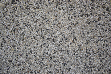 Rough textured wall made from black and white pebbles, abstract background, wall pattern, grunge rock backdrop
