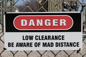 Danger - Low Clearance - Be Aware of MAD Distance sign. The "269" standard identifies required Minimum Approach Distances.