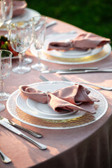 Decorated pink banquet table set with napkin and cutlery