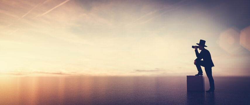 Businessman looking through binoculars searching or looking into future plan