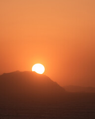 Silhouette of the sun in a beautiful red sunset. Sunset in the coast of the basque country in spain.