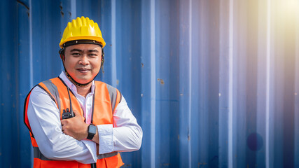Confident asian male engineer portrait in uniform standing in front of the container. Logistics and shipping. Professional occupation.