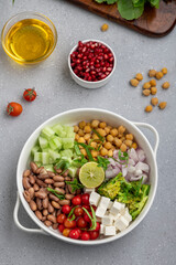 salad made of green veggies, lettuce, cottage cheese, beans, and legumes