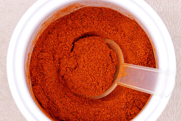 top view powdered red pepper in a glass bowl