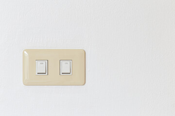 Lighting switch on white concrete background with copy space