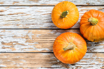Autumn Pumpkin Thanksgiving Background, orange pumpkins on a wooden table. White wooden background. Top view. Copy space