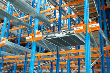 Fototapeta na wymiar Interior view of a warehouse with racks, pallets, goods, forklifts