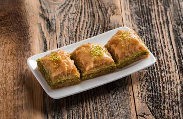 BAKLAVA. Traditional Turkish Desserts Baklava. Crispy pistachio baklava on wooden background.