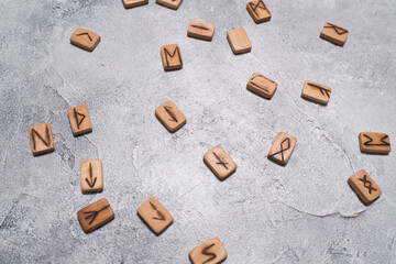 Scandinavian magic runes made of oak on concrete