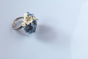 Handmade jewelry. Polymer clay ring. Lies on a white surface.