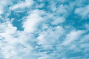 Blurred background. Blue sky and white fluffy clouds.
