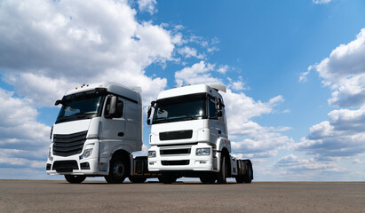 Fototapeta na wymiar Two white trucks against the blue sky 