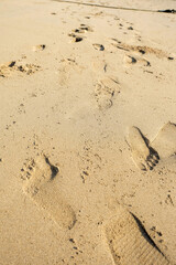 Human footprints on the beach sand (white sand).