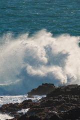 Wave crashing into rocks on bay of fundy coast line