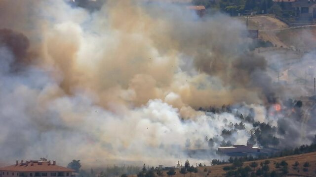 Smoke rises from the area after the terrorist attack. Bomb explodes next to mosques in Muslim country.Terror terrorism attack assault offensive missile rocket fire smoky war fighting wartime warfare
