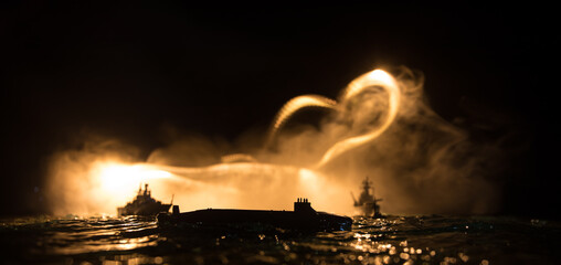 Silhouettes of a crowd standing at blurred military war ship on foggy background. Selective focus....