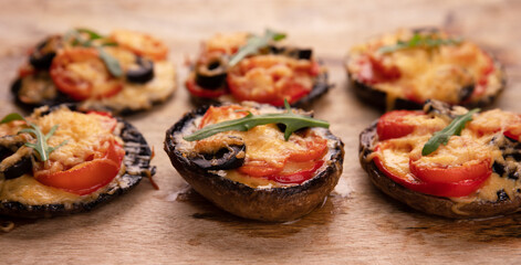 pizza with tomatoes, cheese and pepper on portobello mushrooms