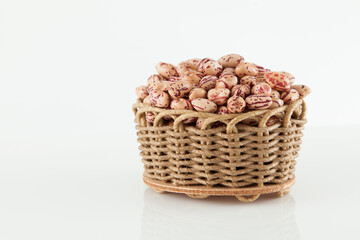 Pinto beans, a legume native to the American continent; photo on white background.