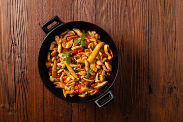 Traditional noodles with shimeji mushrooms and chicken. Prepared in a wok.