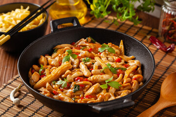 Traditional noodles with shimeji mushrooms and chicken. Prepared in a wok.