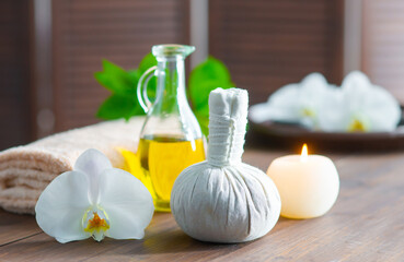 Spa background. Towel, candles, orchid flowers and herbal balls. Massage, oriental therapy, wellbeing and meditation.