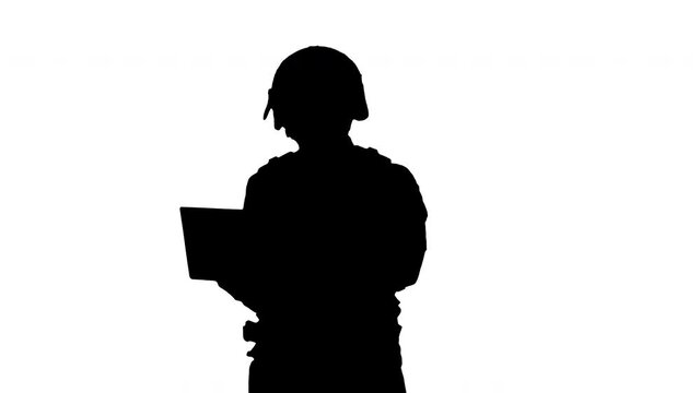 Silhouette Masked Police Officer Using a Laptop Computer.