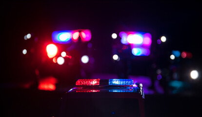 Police cars at night. Police car chasing a car at night with fog background. 911 Emergency response police car speeding to scene of crime. © zef art