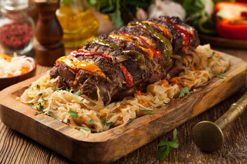 Roasted whole in sauerkraut, stuffed pork neck.