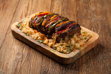 Roasted whole in sauerkraut, stuffed pork neck.