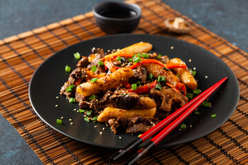 Traditional Korean Tteokbokki rice noodles with beef, vegetables and shitake mushrooms. Prepared in a wok.