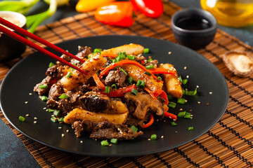 Traditional Korean Tteokbokki rice noodles with beef, vegetables and shitake mushrooms. Prepared in a wok.