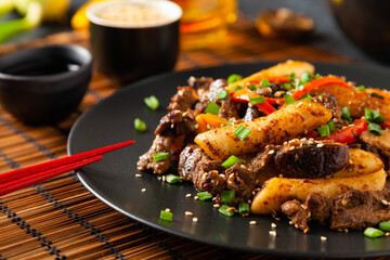 Traditional Korean Tteokbokki rice noodles with beef, vegetables and shitake mushrooms. Prepared in a wok.