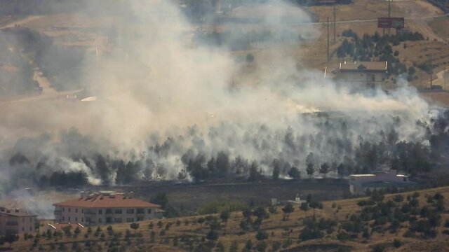 Smoke rises from the area after the terrorist attack. Bomb explodes next to mosques in Muslim country.Terror terrorism attack assault offensive missile rocket fire smoky war fighting wartime warfare