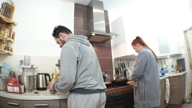 a married couple makes their own breakfast before work