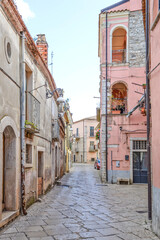 A narrow street among the old houses of Venosa, a medieval village in the Basilicata region, Italy.
