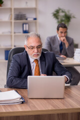 Two employees sitting at workplace