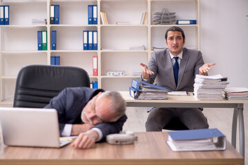 Two employees sitting at workplace