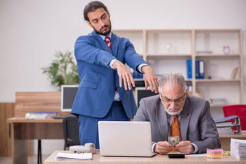 Old male boss and young male employee in remuneration concept