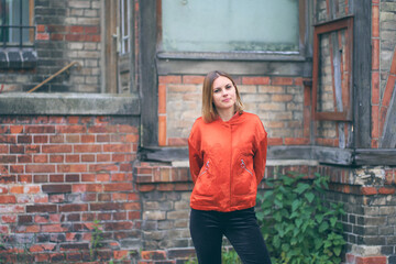 Street style. Beautiful young woman wear fashion clothes with urban background.