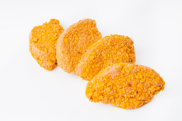 Four slices Breaded chicken fillet in the form of a medallion, sliced on a white background....