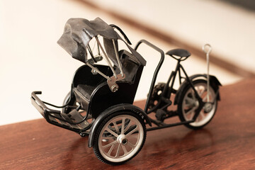 A toy tricycle or Cyclo on a wooden floor