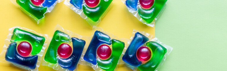 capsules for washing with green, blue and re gel on colorful background. liquid Laundry Detergent Pod. Washing gel .copy space. web banner