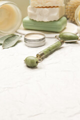 Natural organic skin care product. Home spa and self care concept. Facial serums, creams, jade roller and soap bars with copy space.