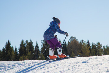 Skier skiing on the slopes of the mountain. Winter sports.