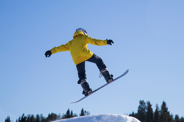 A snowboarder on a snowboard. Extreme winter sports.Rest in winter.