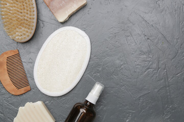  Various toiletries on textured gray background, top view with copy space