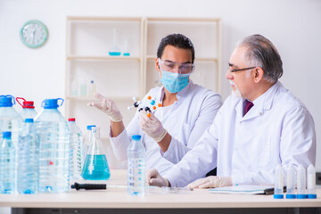 Two chemists working in the lab