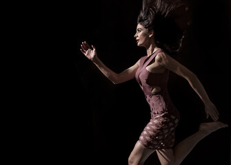 Conceptual photo of an elegant lady running in shade